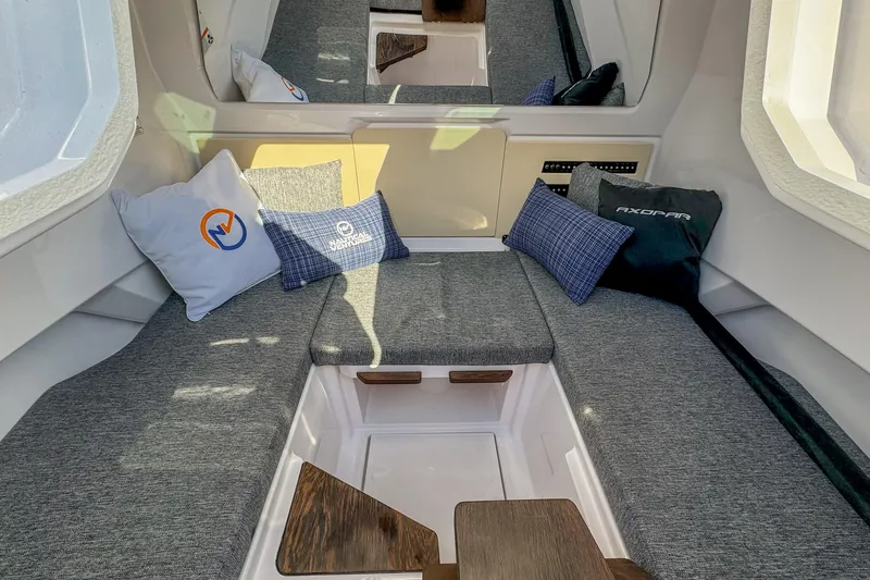  Yacht Photos Pics 2026 Axopar 29 Sun Top interior with gray seating and decorative pillows.
