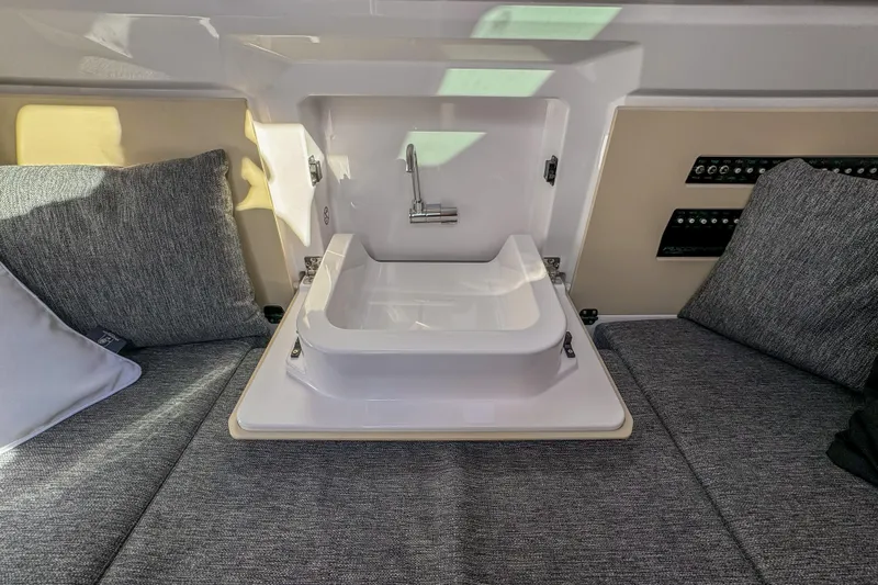  Yacht Photos Pics Interior of 2026 Axopar 29 Sun Top with compact sink and gray cushions.