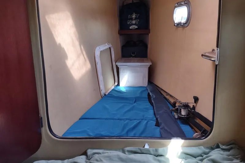 Nyango Yacht Photos Pics Interior cabin of 1996 Fountaine Pajot Venezia 42 catamaran with blue bedding.