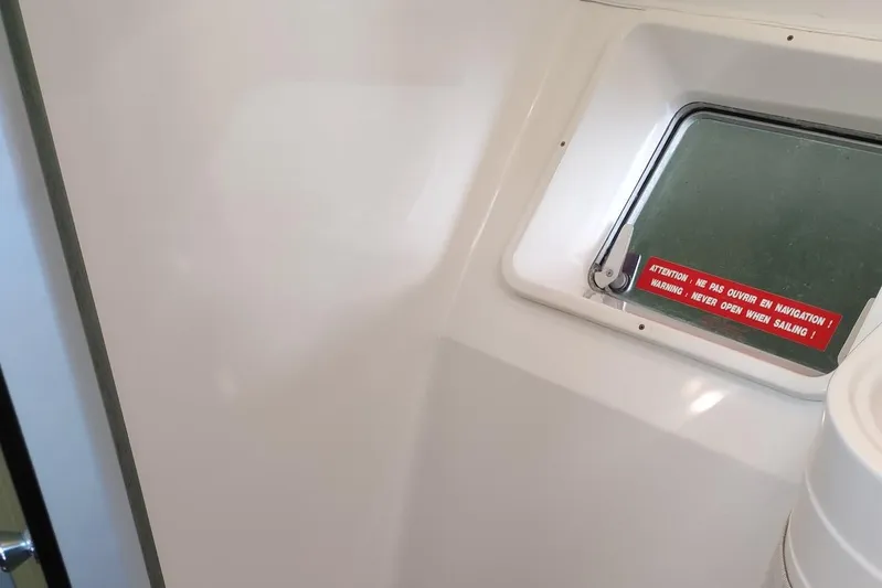 Nyango Yacht Photos Pics Interior of 1996 Fountaine Pajot Venezia 42 with window and safety notice.