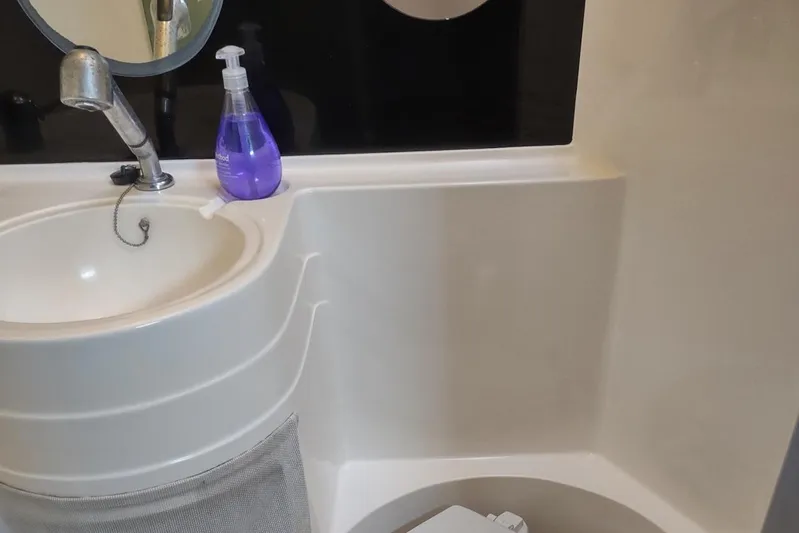 Nyango Yacht Photos Pics Bathroom interior of 1996 Fountaine Pajot Venezia 42 catamaran with sink and mirror.