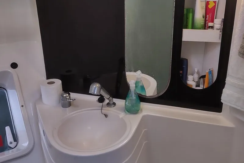 Nyango Yacht Photos Pics Bathroom interior of 1996 Fountaine Pajot Venezia 42 catamaran with sink and mirror.