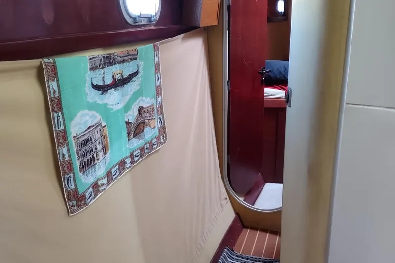 Nyango Yacht Photos Pics Interior of 1996 Fountaine Pajot Venezia 42 catamaran with decorative towel and wooden flooring.