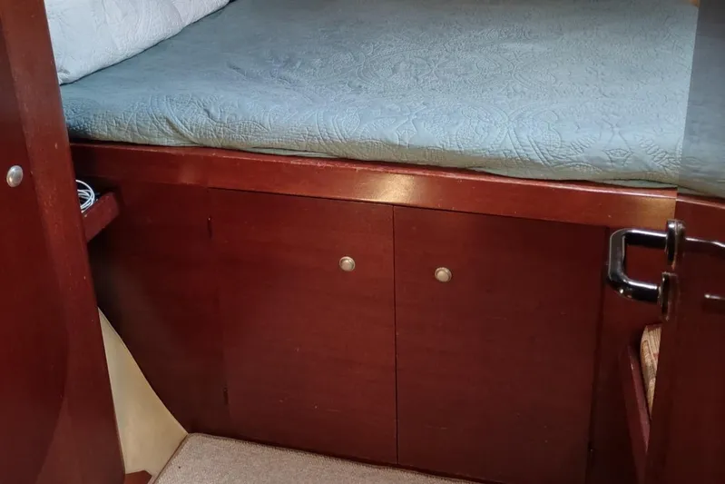 Nyango Yacht Photos Pics Interior cabin of 1996 Fountaine Pajot Venezia 42 with wooden storage and bed.