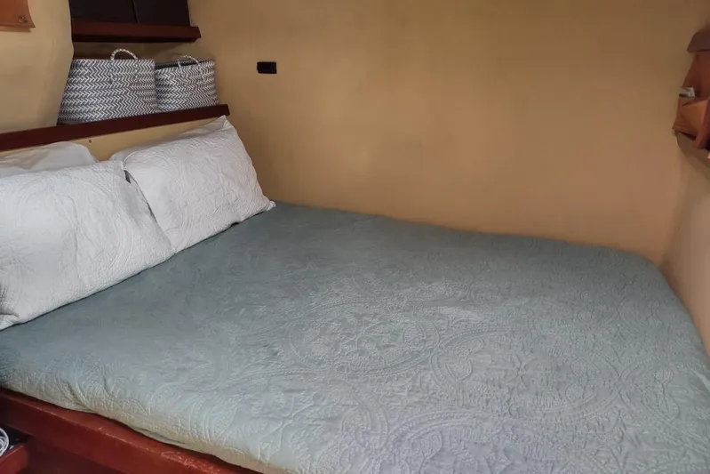 Nyango Yacht Photos Pics Cozy bedroom interior of 1996 Fountaine Pajot Venezia 42 catamaran with blue bedding.