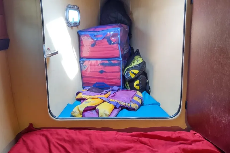 Nyango Yacht Photos Pics Storage area in a 1996 Fountaine Pajot Venezia 42 with life jackets and gear.