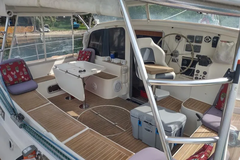 Nyango Yacht Photos Pics 1996 Fountaine Pajot Venezia 42 catamaran interior with seating, table, and navigation controls.