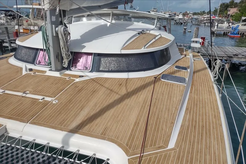 Nyango Yacht Photos Pics 1996 Fountaine Pajot Venezia 42 catamaran with teak deck, docked in a marina.