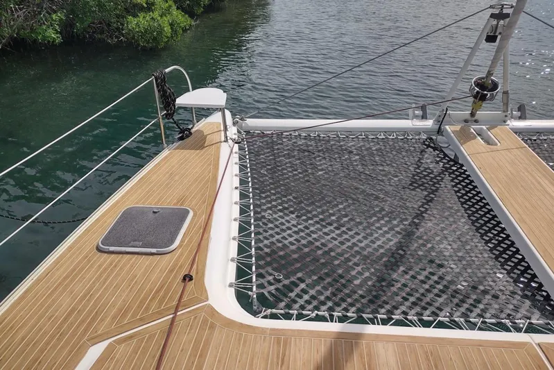 Nyango Yacht Photos Pics Deck of 1996 Fountaine Pajot Venezia 42 catamaran with netting and water view.