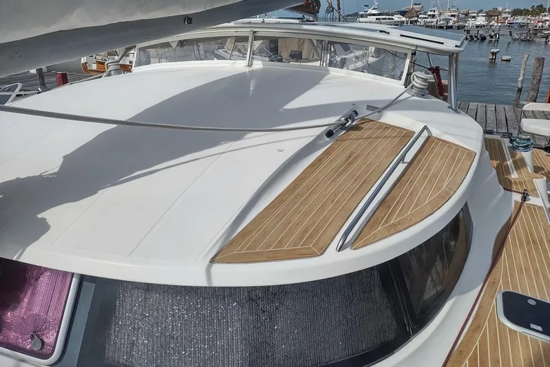 Nyango Yacht Photos Pics 1996 Fountaine Pajot Venezia 42 catamaran docked at marina, featuring sleek deck design.