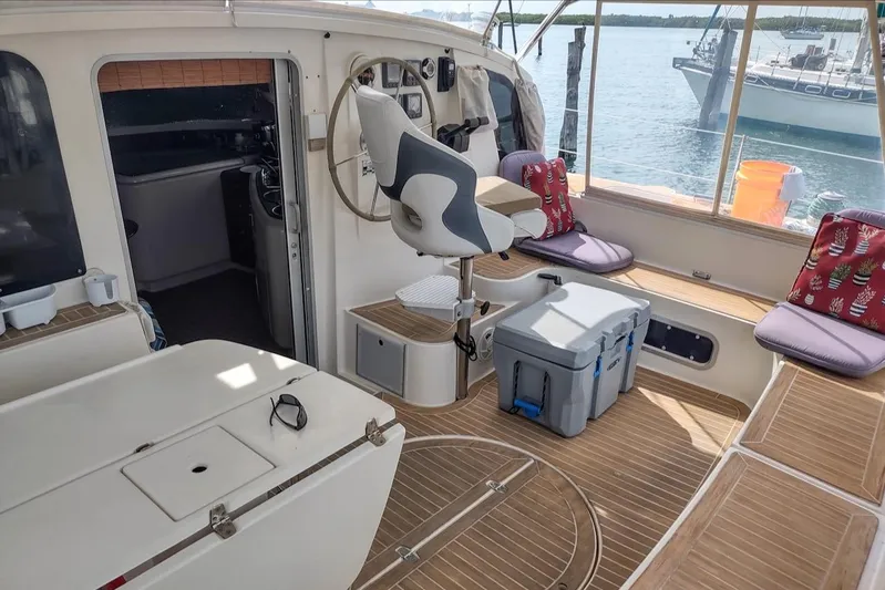 Nyango Yacht Photos Pics 1996 Fountaine Pajot Venezia 42 catamaran interior with seating, helm, and ocean view.