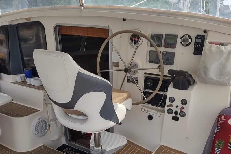 Nyango Yacht Photos Pics Helm of 1996 Fountaine Pajot Venezia 42 catamaran with steering wheel and navigation instruments.