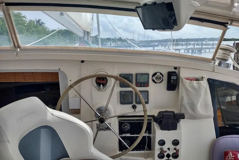 Nyango Yacht Photos Pics Cockpit of 1996 Fountaine Pajot Venezia 42 catamaran with steering wheel and navigation instruments.