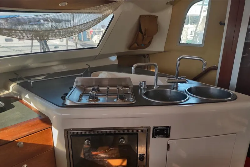 Nyango Yacht Photos Pics Interior of 1996 Fountaine Pajot Venezia 42 catamaran kitchen with stove and dual sinks.