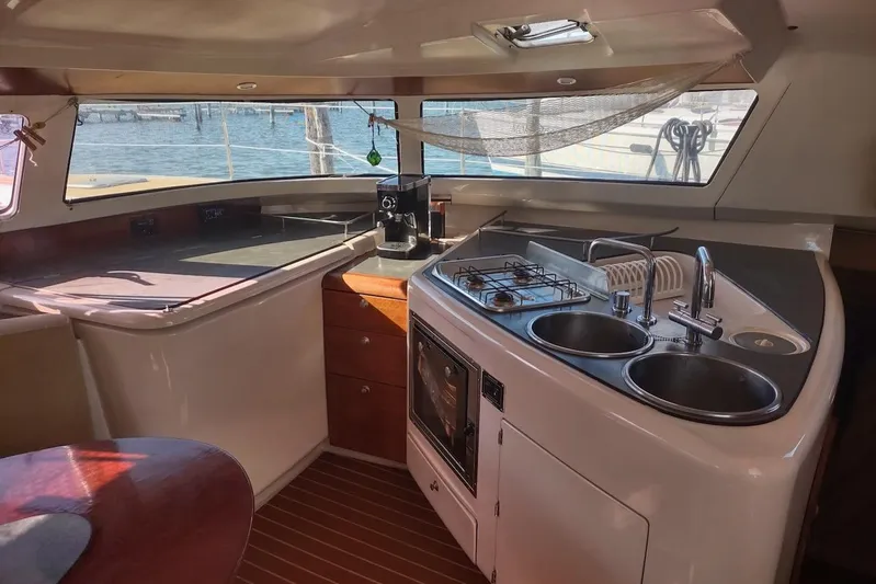 Nyango Yacht Photos Pics Interior of 1996 Fountaine Pajot Venezia 42 catamaran kitchen with stove and sink.