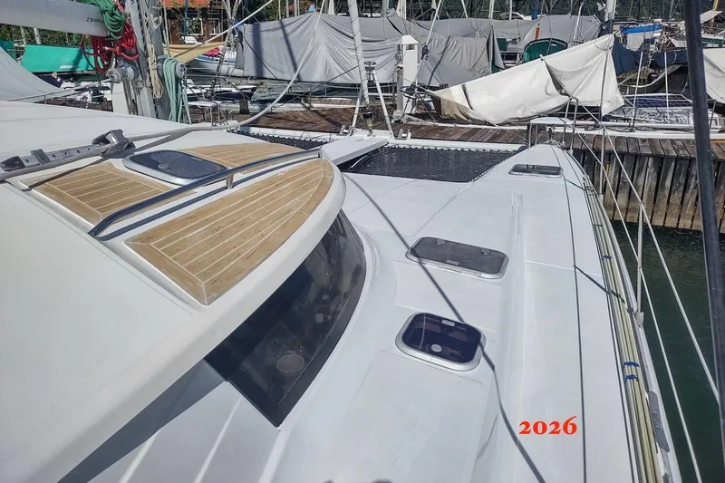 Nyango Yacht Photos Pics Fountaine Pajot Venezia 42 catamaran, 1996 model, docked at marina with covered boats.