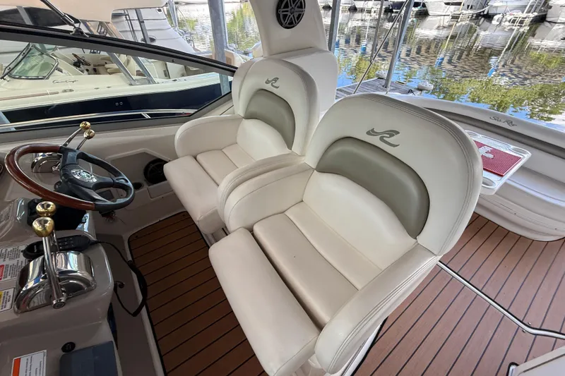 Magpie Yacht Photos Pics 2006 Sea Ray 340 Sundancer cockpit with dual helm seats and wooden deck.