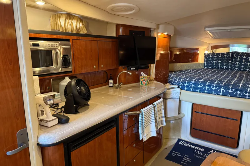 Magpie Yacht Photos Pics Interior of 2006 Sea Ray 340 Sundancer with kitchenette and cozy sleeping area.