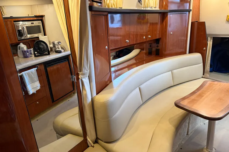 Magpie Yacht Photos Pics Luxurious interior of 2006 Sea Ray 340 Sundancer with kitchenette and curved seating.