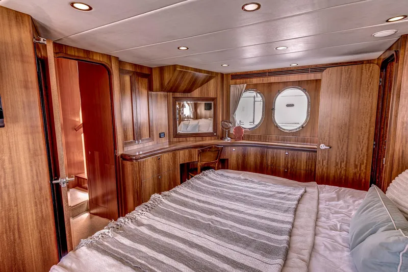 Bora Bora Yacht Photos Pics Luxurious yacht bedroom with wood paneling, round windows, and cozy bedding, Paragon mk 2009 model.