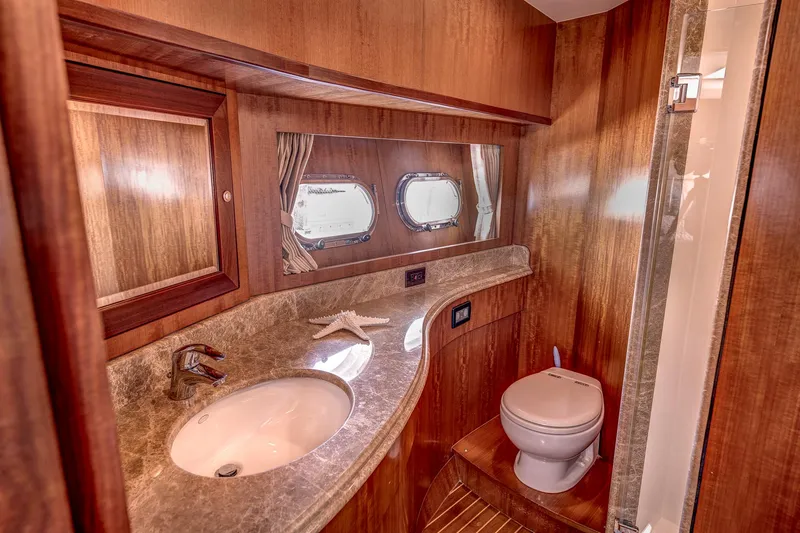 Bora Bora Yacht Photos Pics Luxurious yacht bathroom with wooden interior, marble countertop, and porthole windows, Paragon mk 2009.