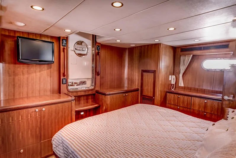 Bora Bora Yacht Photos Pics Luxurious yacht cabin interior with wood paneling, bed, TV, and porthole, Paragon mk 2009 model.