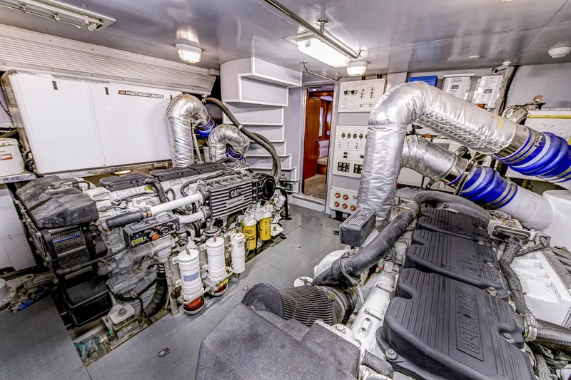 Bora Bora Yacht Photos Pics Engine room of a 2009 Paragon MK yacht, featuring dual engines and control panels.