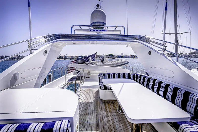 Bora Bora Yacht Photos Pics Luxurious 2009 Paragon MK yacht deck with striped seating and dining area.