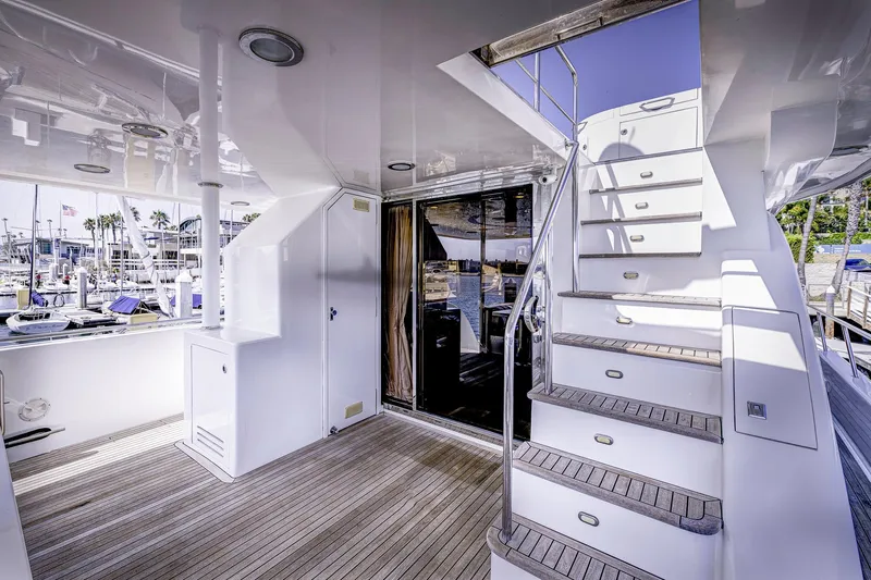 Bora Bora Yacht Photos Pics Luxurious yacht deck with stairs, wooden flooring, and marina view; Paragon mk 2009 model.