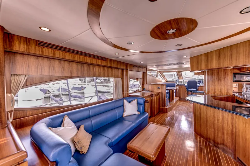 Bora Bora Yacht Photos Pics Luxurious yacht interior with blue seating, wooden finishes, and large windows, Paragon mk 2009 model.