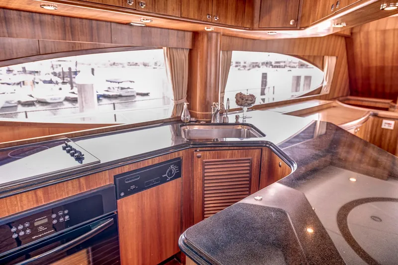 Bora Bora Yacht Photos Pics Luxurious yacht kitchen interior with wood cabinetry, modern appliances, and marina view, Paragon mk 2009.