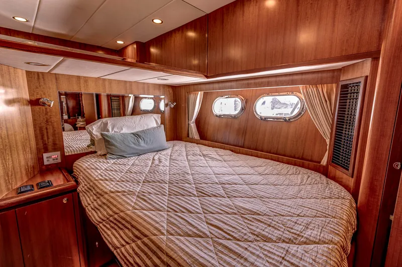 Bora Bora Yacht Photos Pics Luxurious yacht bedroom with wood paneling, porthole windows, and cozy bedding, Paragon mk 2009.