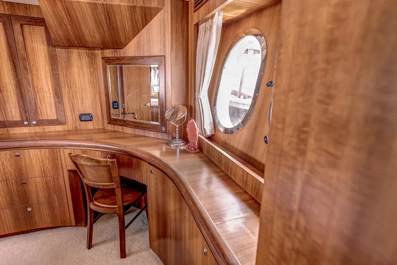 Bora Bora Yacht Photos Pics Luxurious wooden interior of a 2009 Paragon mk yacht with porthole and seating area.