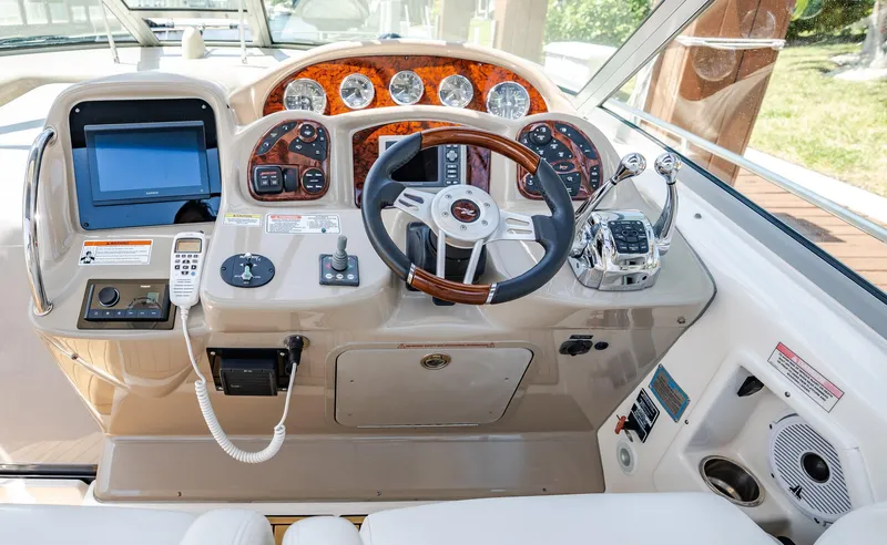 Bella Vita Yacht Photos Pics 2008 Sea Ray 340 Sundancer helm with steering wheel, gauges, and navigation controls.
