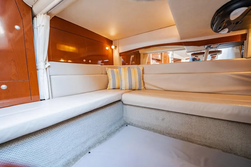 Bella Vita Yacht Photos Pics Interior of 2008 Sea Ray 340 Sundancer with beige seating and striped cushions.
