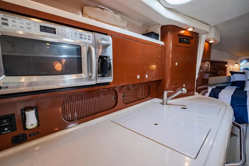 Bella Vita Yacht Photos Pics 2008 Sea Ray 340 Sundancer interior kitchen with microwave and sink.