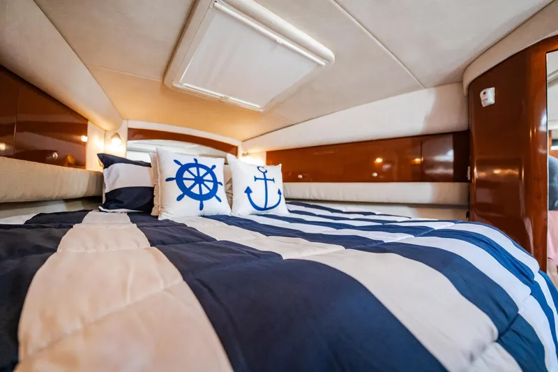 Bella Vita Yacht Photos Pics Luxurious cabin interior of 2008 Sea Ray 340 Sundancer with nautical-themed bedding.