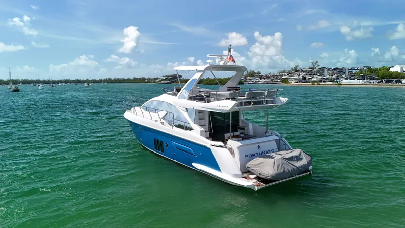 Fortunato Yacht Photos Pics Azimut 50 Flybridge 2016 yacht on turquoise water under a clear blue sky.