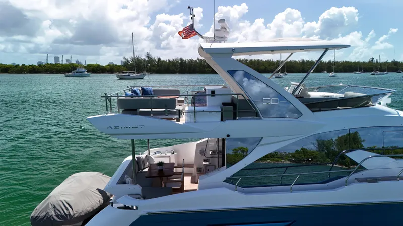Fortunato Yacht Photos Pics Azimut 50 Flybridge 2016 yacht on serene water with clear skies and distant boats.