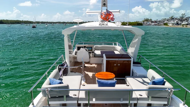 Fortunato Yacht Photos Pics Azimut 50 Flybridge 2016 yacht on serene water, featuring spacious deck and luxurious seating.