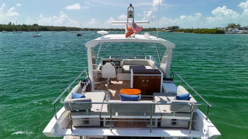Fortunato Yacht Photos Pics 2016 Azimut 50 Flybridge yacht on serene green waters, featuring spacious deck and seating.