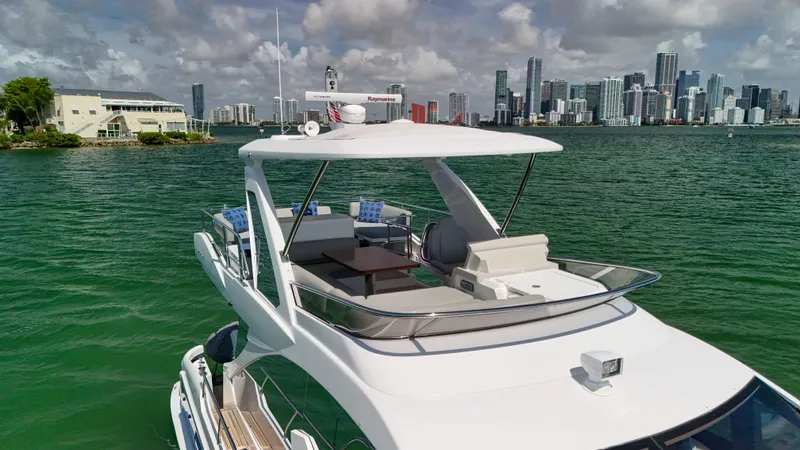 Fortunato Yacht Photos Pics 2016 Azimut 50 Flybridge yacht on water with city skyline in background.