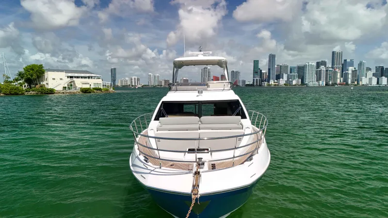 Fortunato Yacht Photos Pics 2016 Azimut 50 Flybridge yacht on water with city skyline in background.