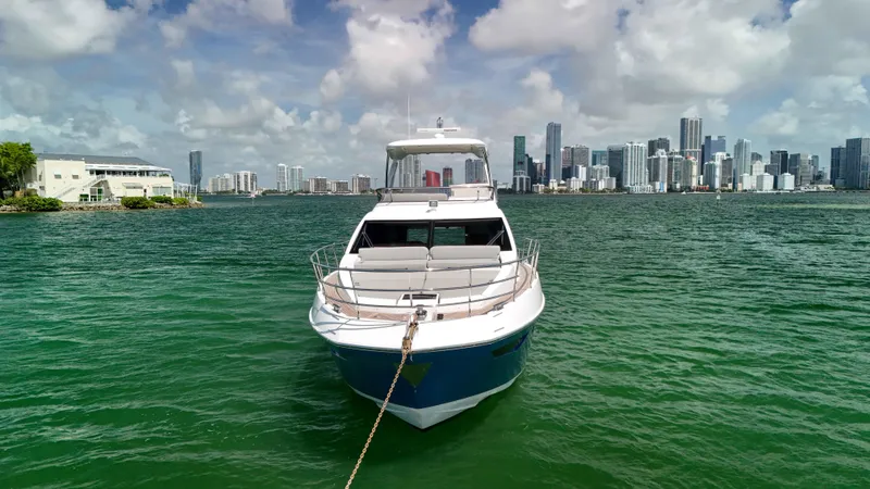 Fortunato Yacht Photos Pics 2016 Azimut 50 Flybridge yacht anchored with city skyline in background.