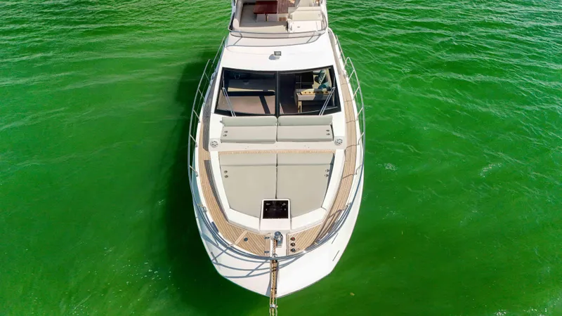 Fortunato Yacht Photos Pics Aerial view of 2016 Azimut 50 Flybridge yacht on vibrant green water.