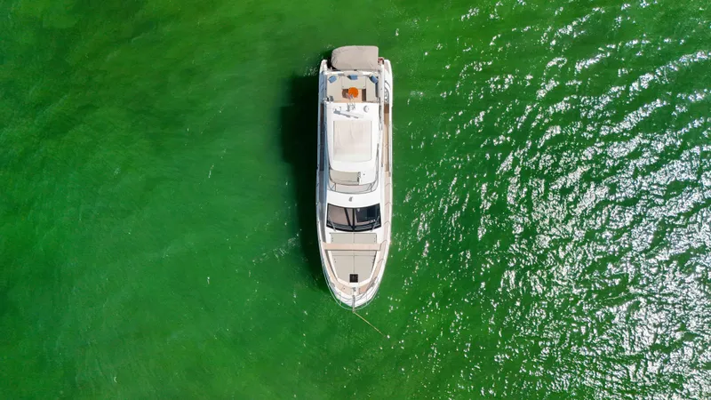 Fortunato Yacht Photos Pics Overhead view of 2016 Azimut 50 Flybridge yacht on vibrant green water.