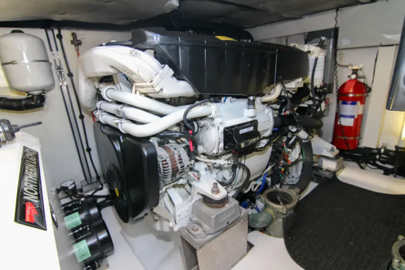 Fortunato Yacht Photos Pics Engine room of 2016 Azimut 50 Flybridge yacht, featuring complex machinery and fire extinguisher.