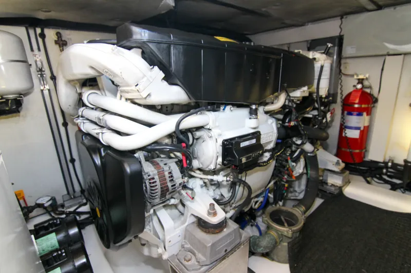 Fortunato Yacht Photos Pics Engine room of 2016 Azimut 50 Flybridge yacht, featuring complex machinery and fire extinguisher.