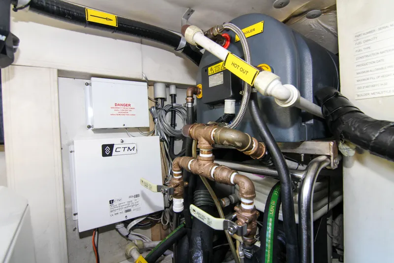 Fortunato Yacht Photos Pics Engine room of 2016 Azimut 50 Flybridge yacht, featuring complex piping and equipment.