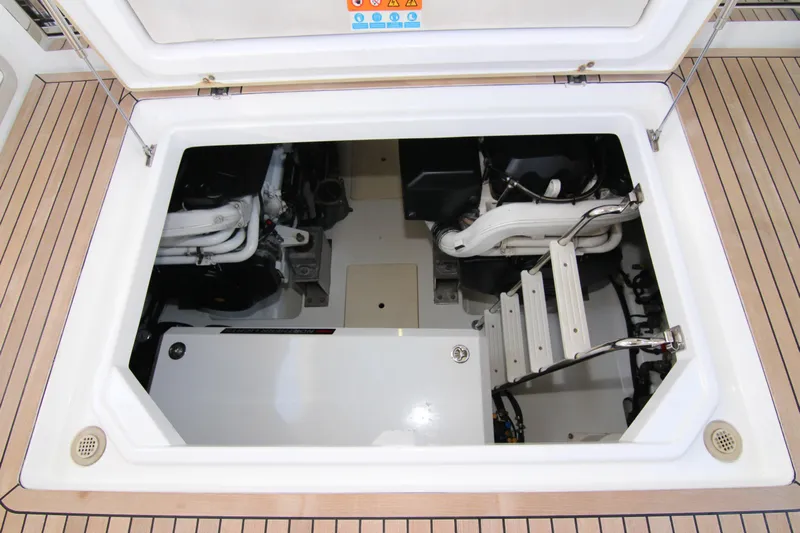 Fortunato Yacht Photos Pics Engine compartment of 2016 Azimut 50 Flybridge yacht, showcasing mechanical components and access ladder.